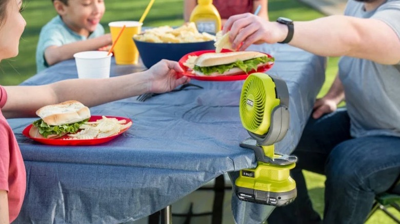 Ryobi One+ 18V Cordless 4-inch Clamp Fan on the edge of a table