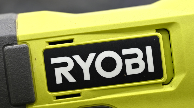 Close-up of the Ryobi logo on a lime green power tool