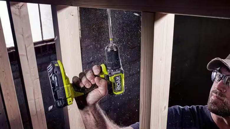 Man using 18V ONE+ HP Compact Brushless 1/2" Drill/Driver to drill holes into wood