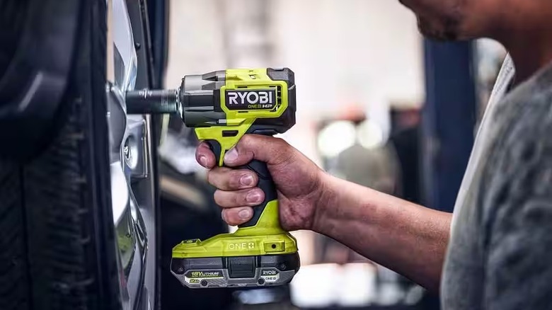 Man using 18V ONE+ HP Compact Brushless 4-Mode 3/8 in. Impact Wrench to tighten lug nuts in tire