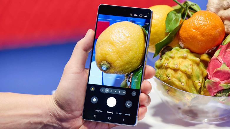 Person taking a photo of a lemon using a Samsung Galaxy S25 Ultra.