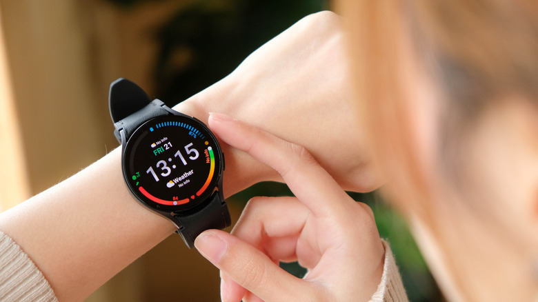 A person interacting with a Galaxy Watch.