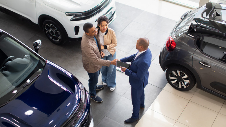 Car dealership deal in showroom