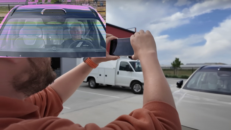 man testing iPhone with Volvo car LiDAR