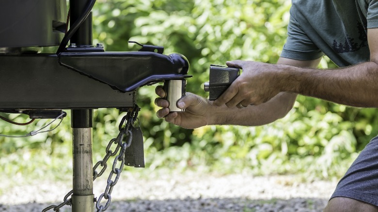 Man working on trailer coupler