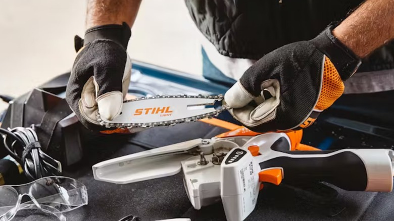 A person maintaining their stihl gta 26 mini cordless pruner