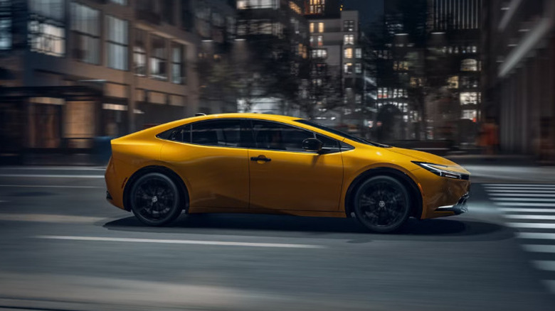 2026 Toyota Prius in yellow driving fast on road