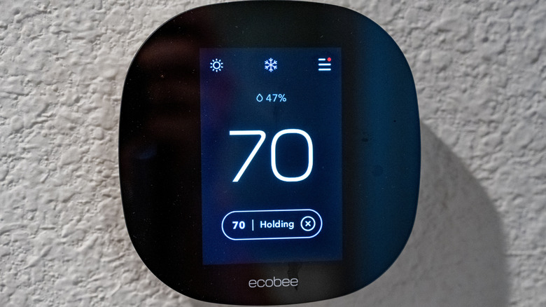 An Ecobee smart home thermostat on a wall.