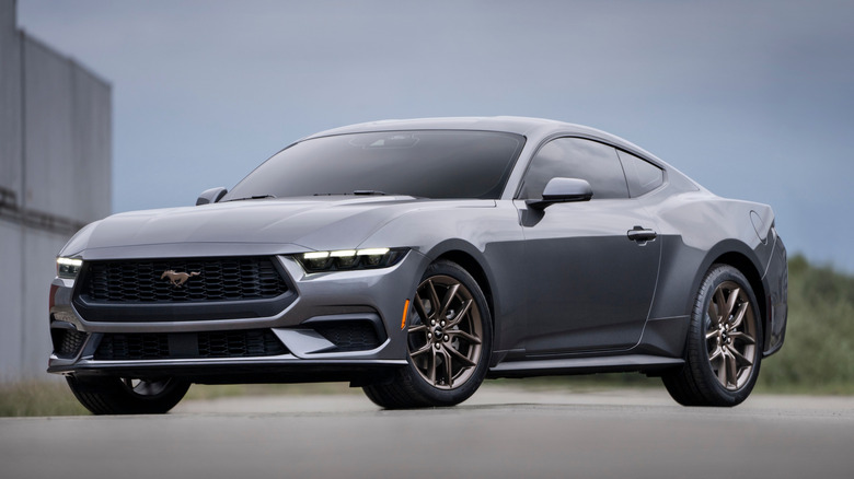 A 2026 Ford Mustang EcoBoost in gray parked near an industrial building
