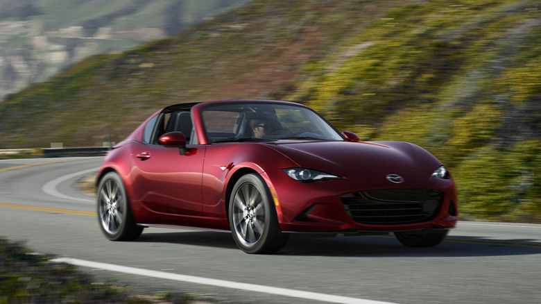 A red 2026 Mazda MX-5 Miata on a windy road