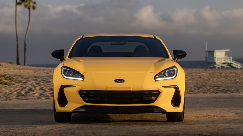 A 2026 Subaru BRZ in bright yellow parked near a beach