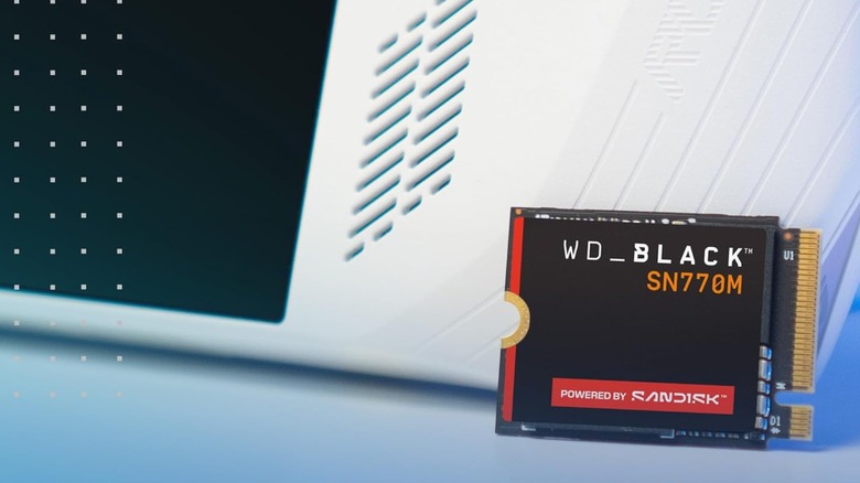A picture of an small SSD next to an Ally ROG handheld console