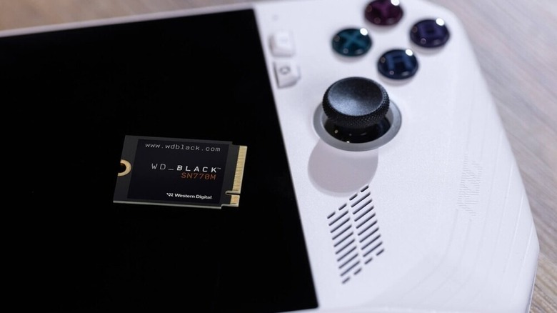 A close up of the WD Black SN770M SSD sitting on top of a ROG Ally handheld gaming console