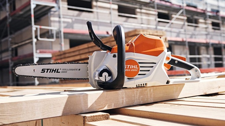 Stihl MSA 200 C-B Chainsaw placed on wood.
