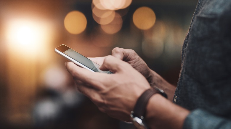 Person typing on smartphone