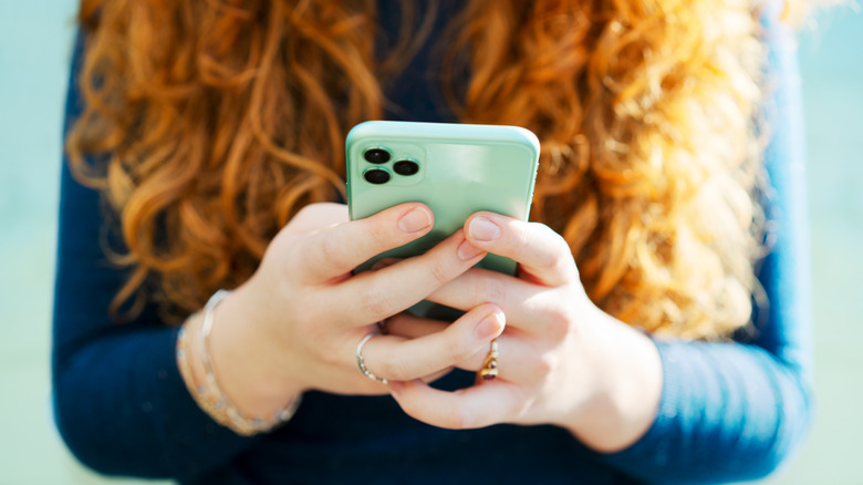 Close up of person holding iPhone