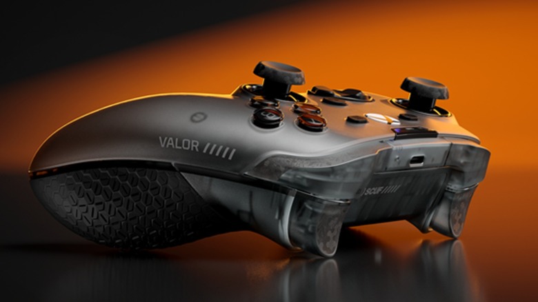 A picture of a Scuf Valor gaming controller with an orange and black background
