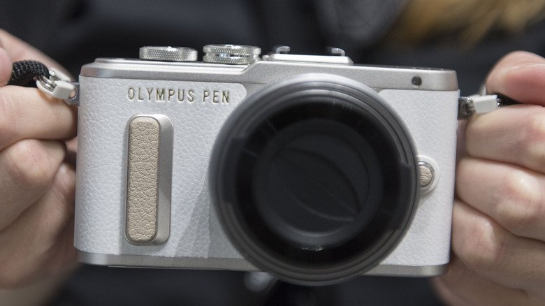 A white Olympus PEN camera