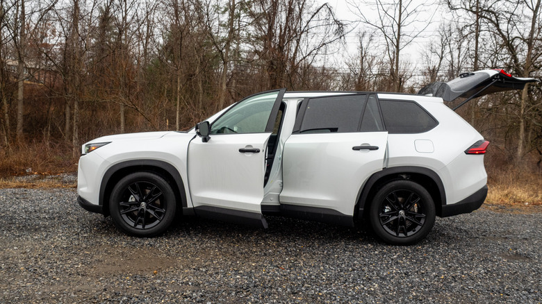 2026 Toyota Grand Highlander Hybrid Nightshade Edition driver-side profile view with doors and rear hatch open