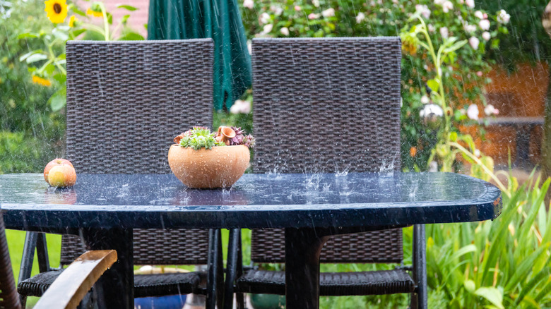 Patio table and chairs during a rainstorm
