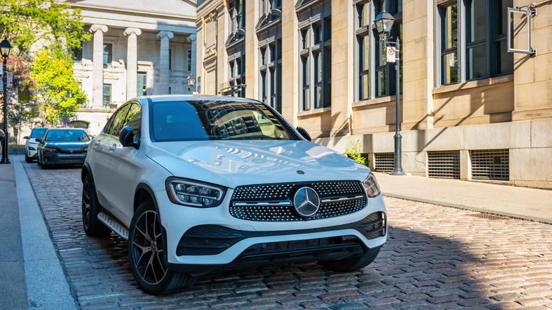 Mercedes-Benz vehicle parked on stone street.