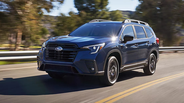 Blue 2026 Subaru Ascent driving cornering on a rural road
