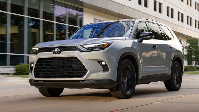 White 2026 Toyota Grand Highlander driving in an urban environment