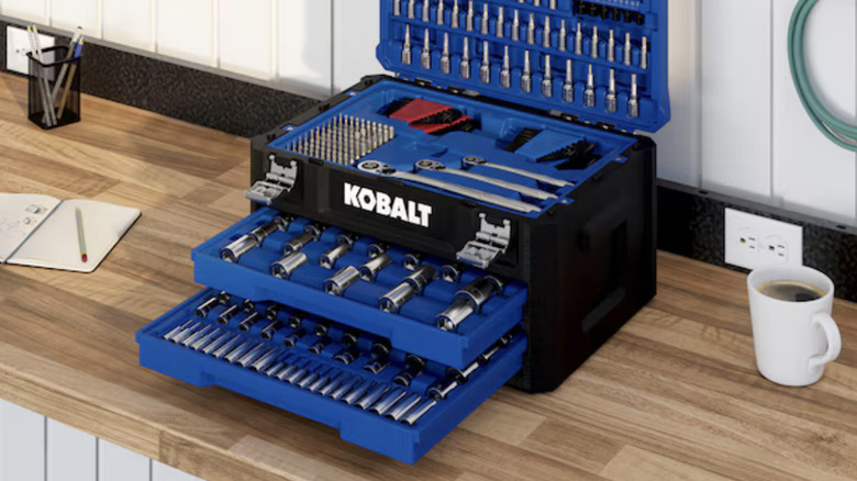 The Kobalt 302-Piece Metric and standard (SAE) Mechanics Tool set sitting open on a wooden counter