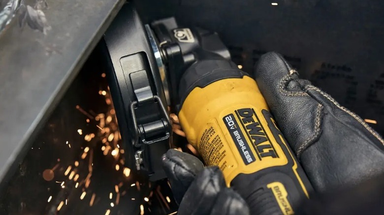 Person using DeWalt Atomic 20V Max Cordless 4 ½-inch Angle Grinder on metal