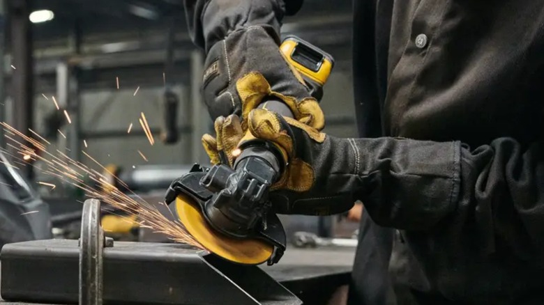 Person using DeWalt Atomic 20V Max Cordless 4 ½-inch Angle Grinder on metal