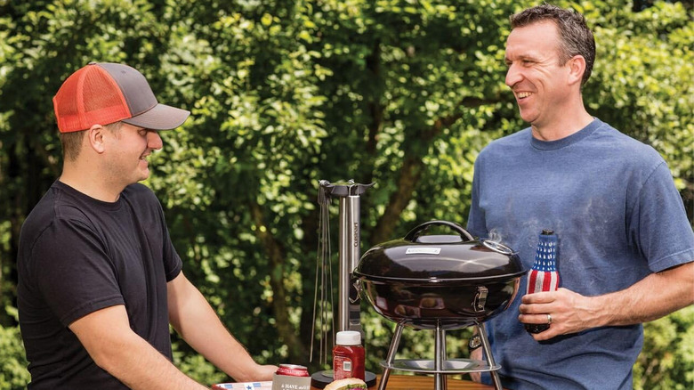 people standing around Cuisinart grill