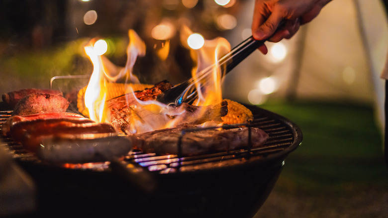 person cooking on a grill