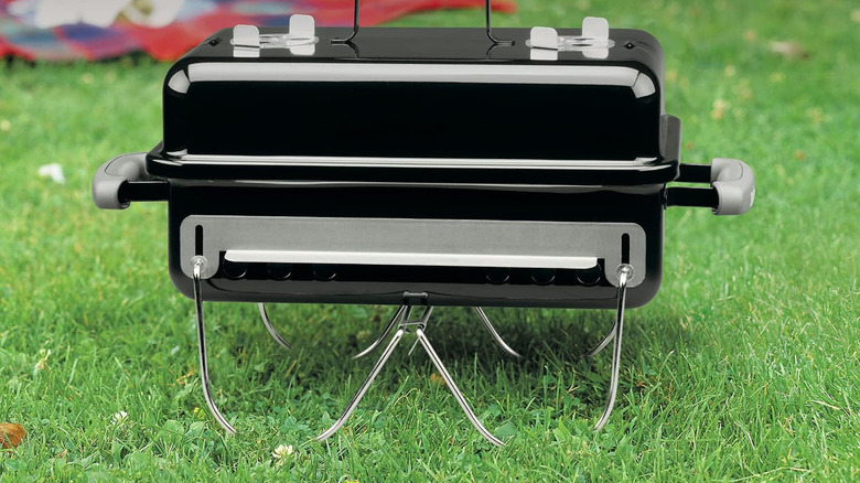 black Weber grill in grass