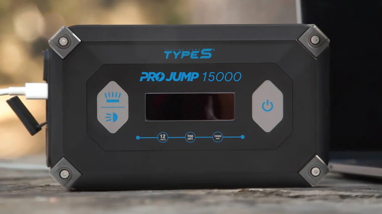 USB cable plugged into a Type S 15000mAh ProJump Starter on a truck