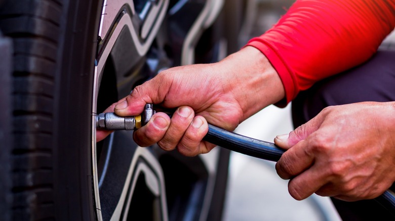 Person filling tire with air