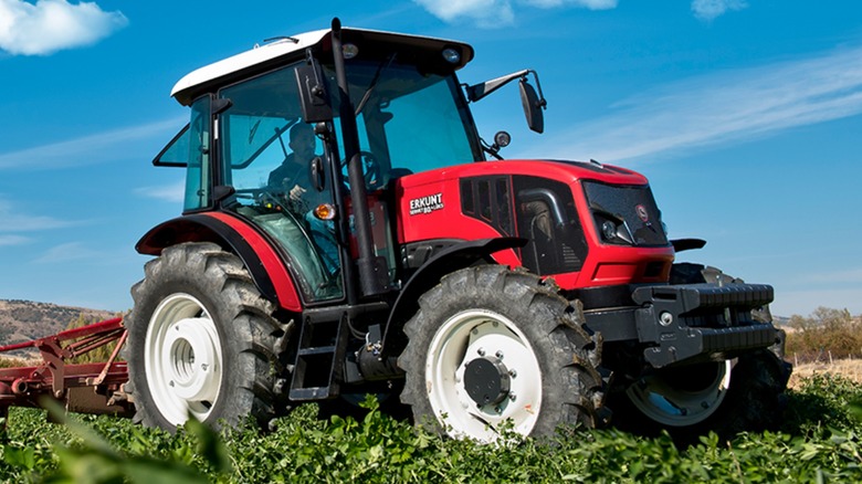 An Erkunt tractor driving through a field.