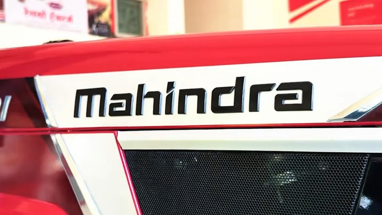 The Mahindra logo on the side of a tractor.