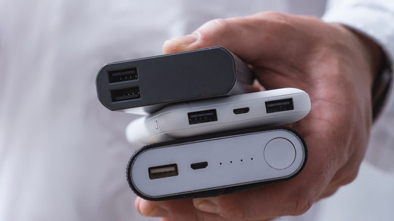 Person holding multiple power banks