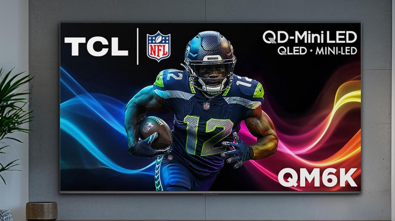 A QLED mini LED TCL TV in a living room, NFL player displayed on the screen.