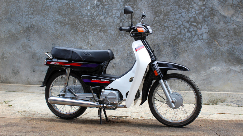 a classic Honda motorcycle parked on concrete