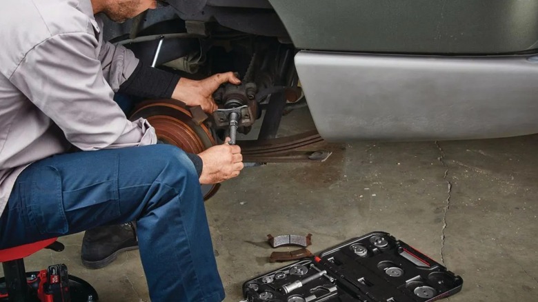 A person using the Icon master brake caliper set to perform a brake job