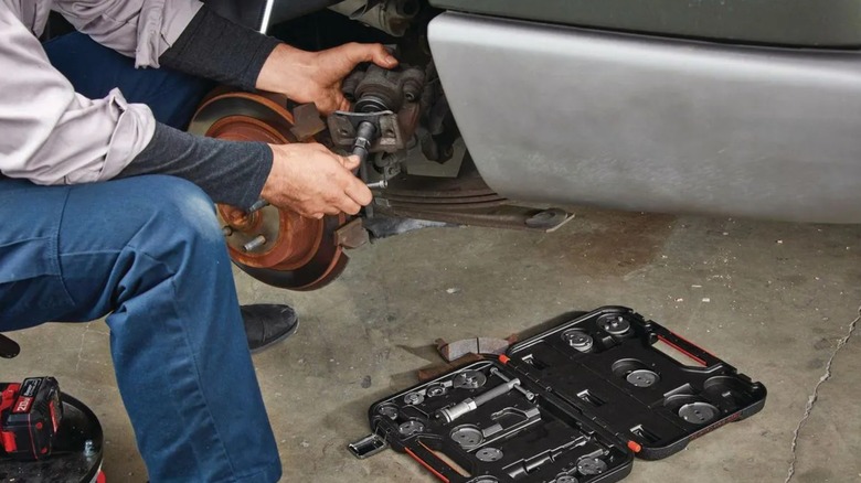 A person using the Icon master brake caliper set to perform a brake job