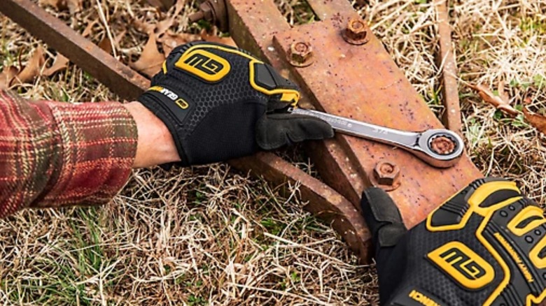 a person using a gearwrench ratcheting wrench