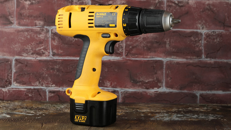 Dewalt drill laying on wood planks