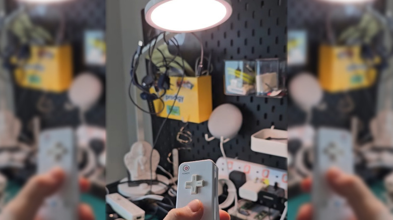 A Wii Remote being used to turn a light on and off.