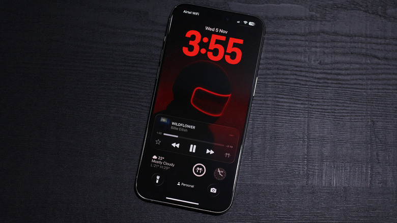 iOS 26 lock screen with music playing