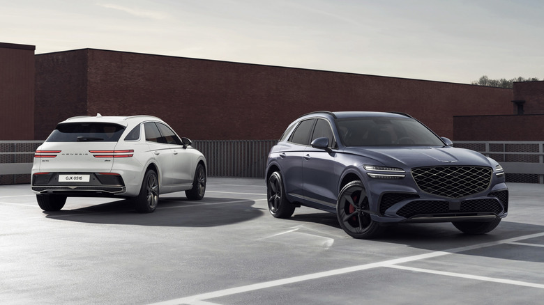 Two Genesis GV70 SUVs parked next to each other in an outdoor urban environment.