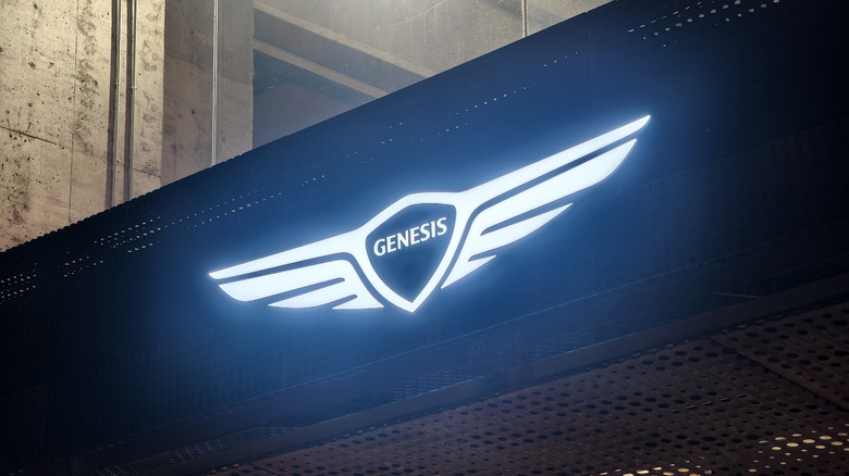 A Genesis brand lighted up logo on a store.