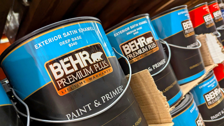 Buckets of Behr paint on the shelf of a Home Depot