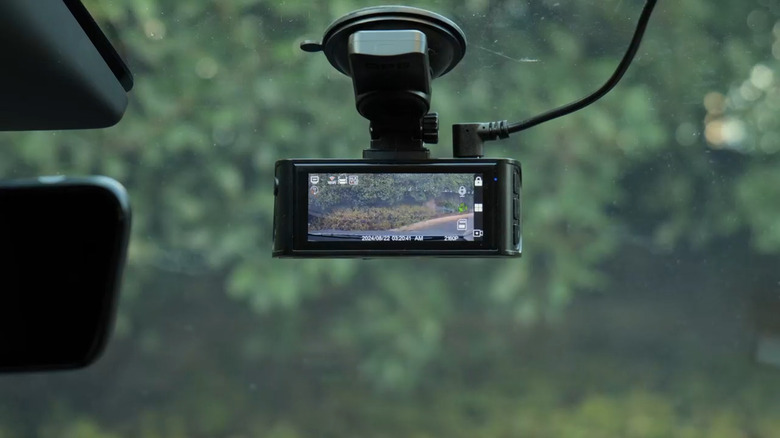 Dashcam on car windshield with USB cable connected